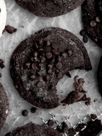 A Deliciously Dark Chocolate Sugar Cookie with granulated sugar and extra chocolate chips melted slightly.
