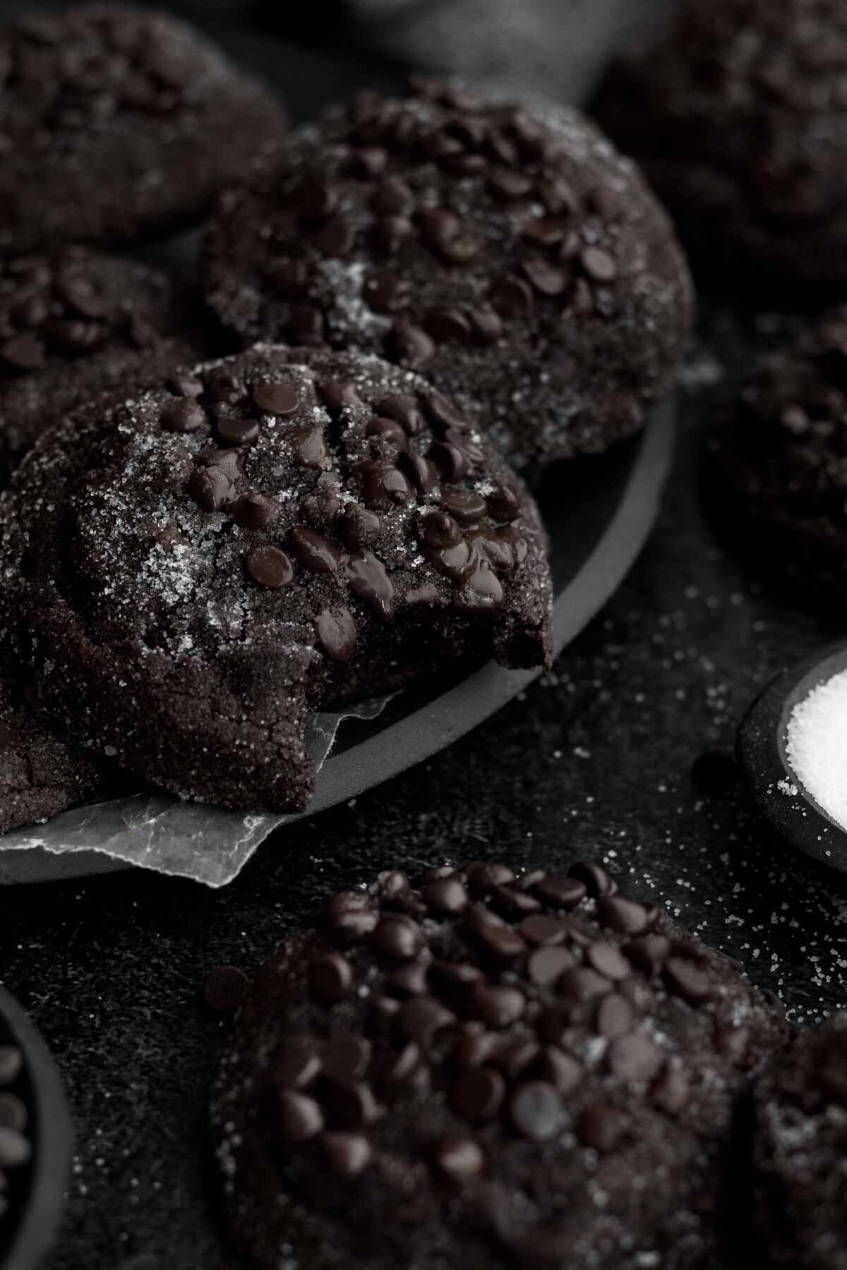 A black plate of dark delicious cookies.