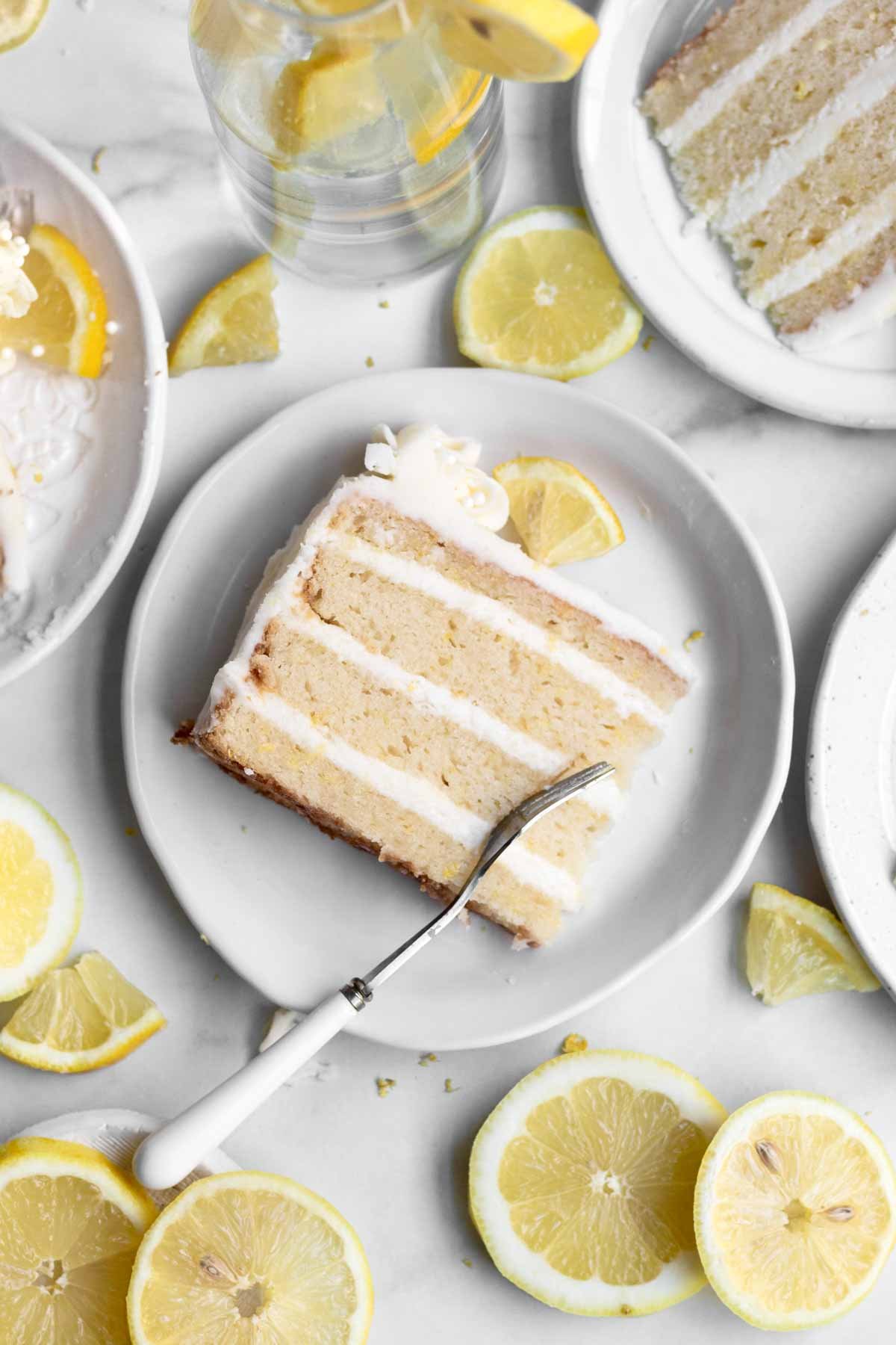 A fancy slice of Gluten Free Lemon Cake with a fork.