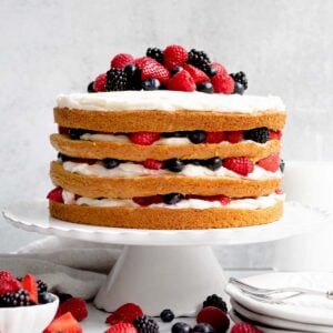 A whole gluten free, nut free cake topped with extra berries.
