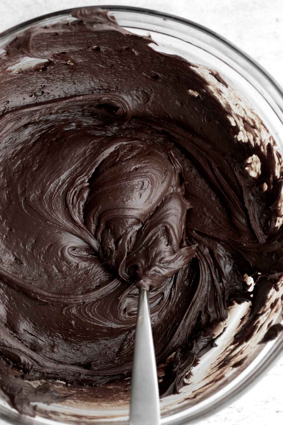 Creamy chocolate fudge with a spoon.