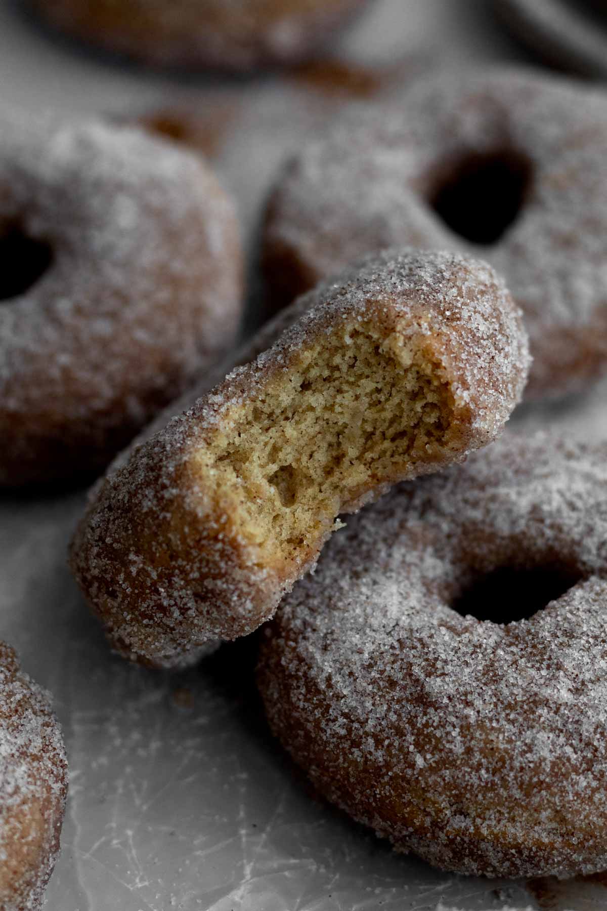 A bitten donut reveals the light and fluffy insides.