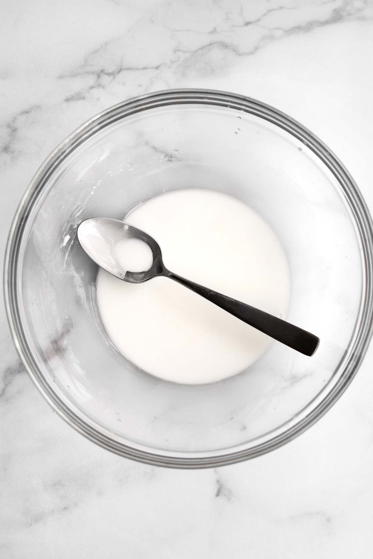 Cornstarch water in a bowl with a spoon.