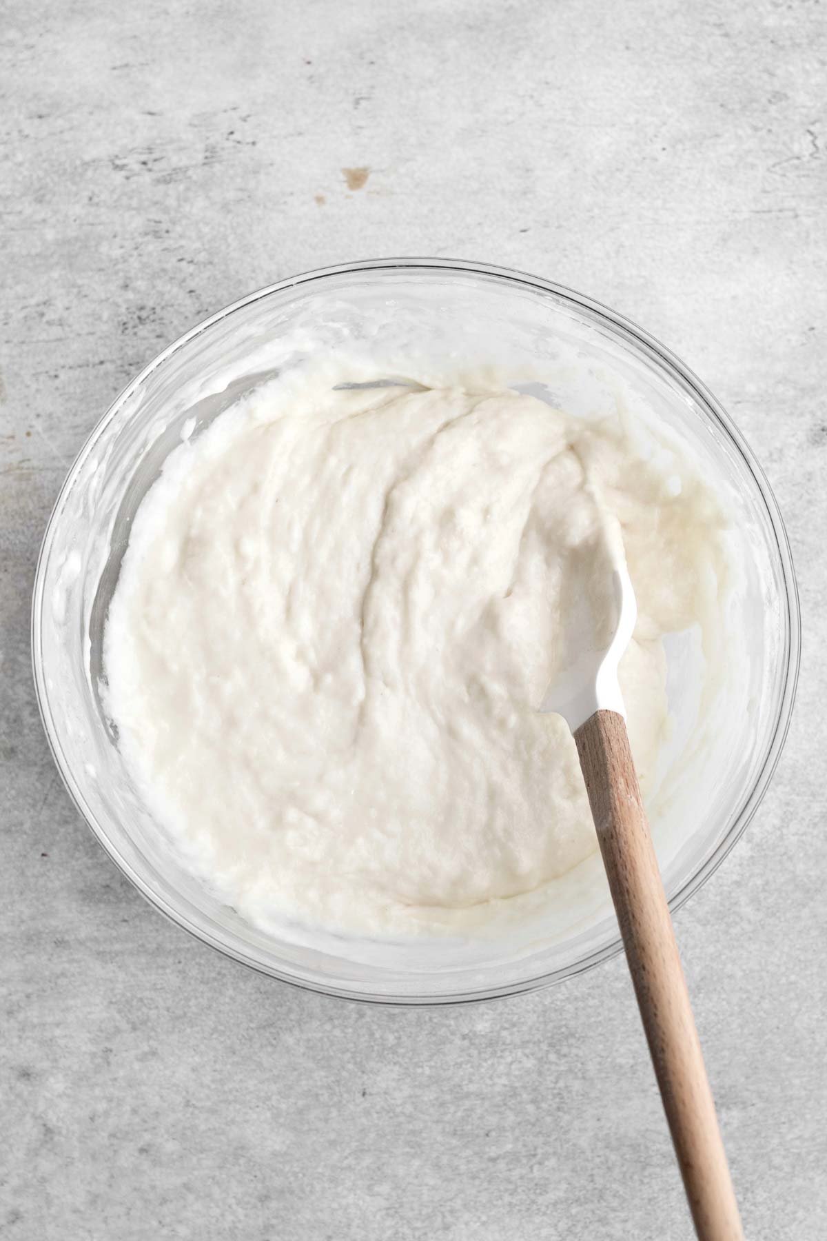 Mixing the wet and dry ingredients into a batter.