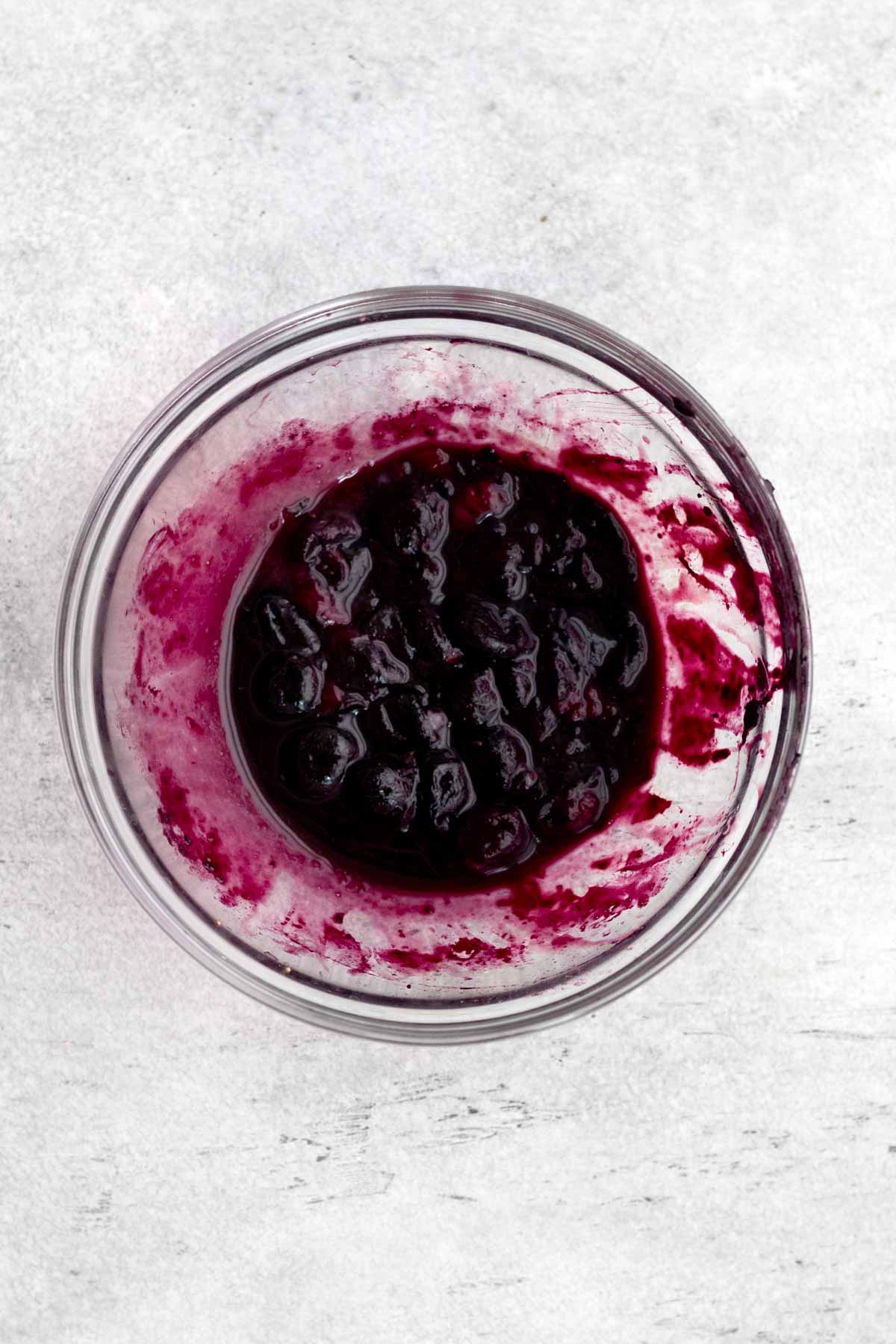 A bowl of blueberries and juice.