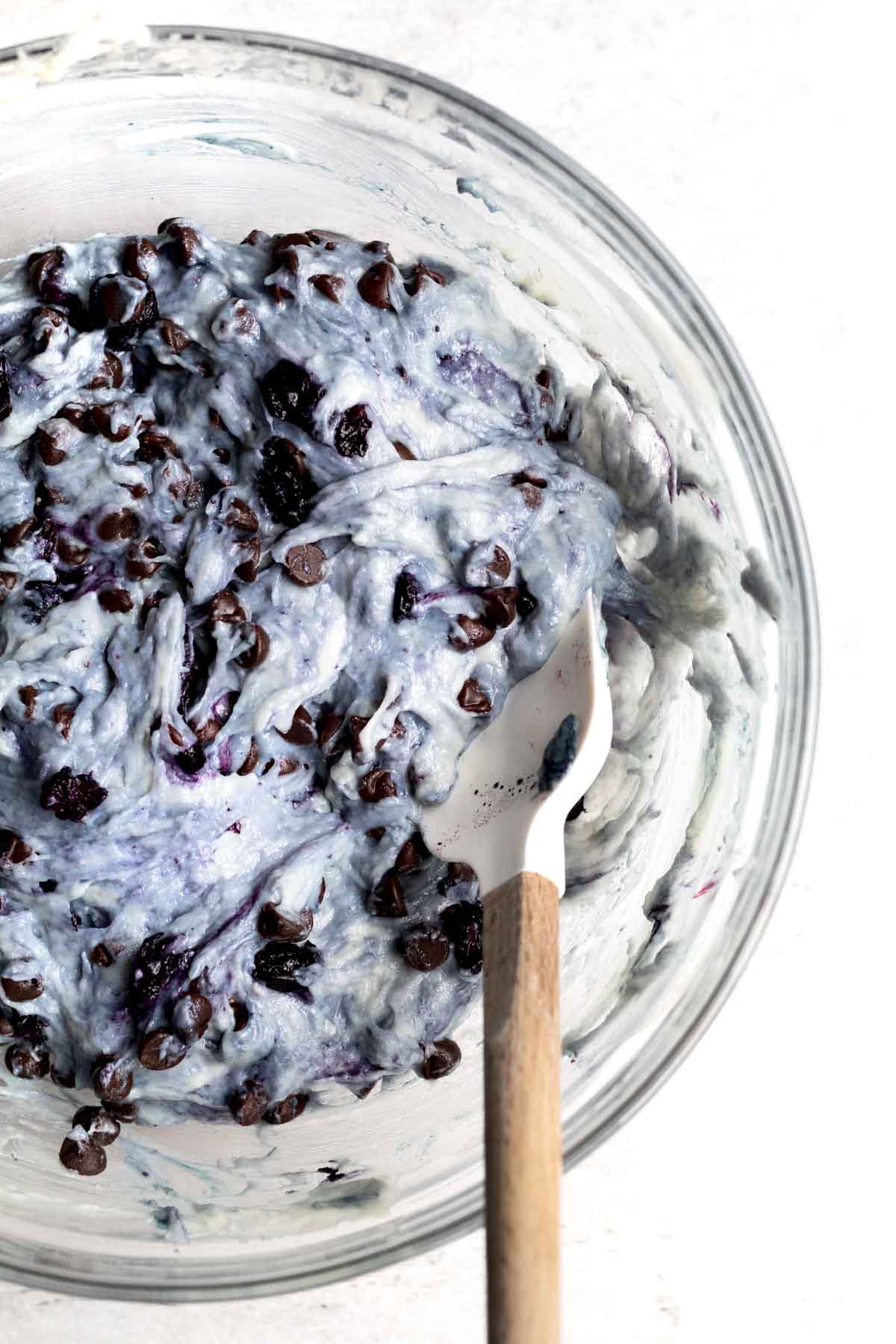 Mixing the chocolate chips thoroughly into the blue batter.