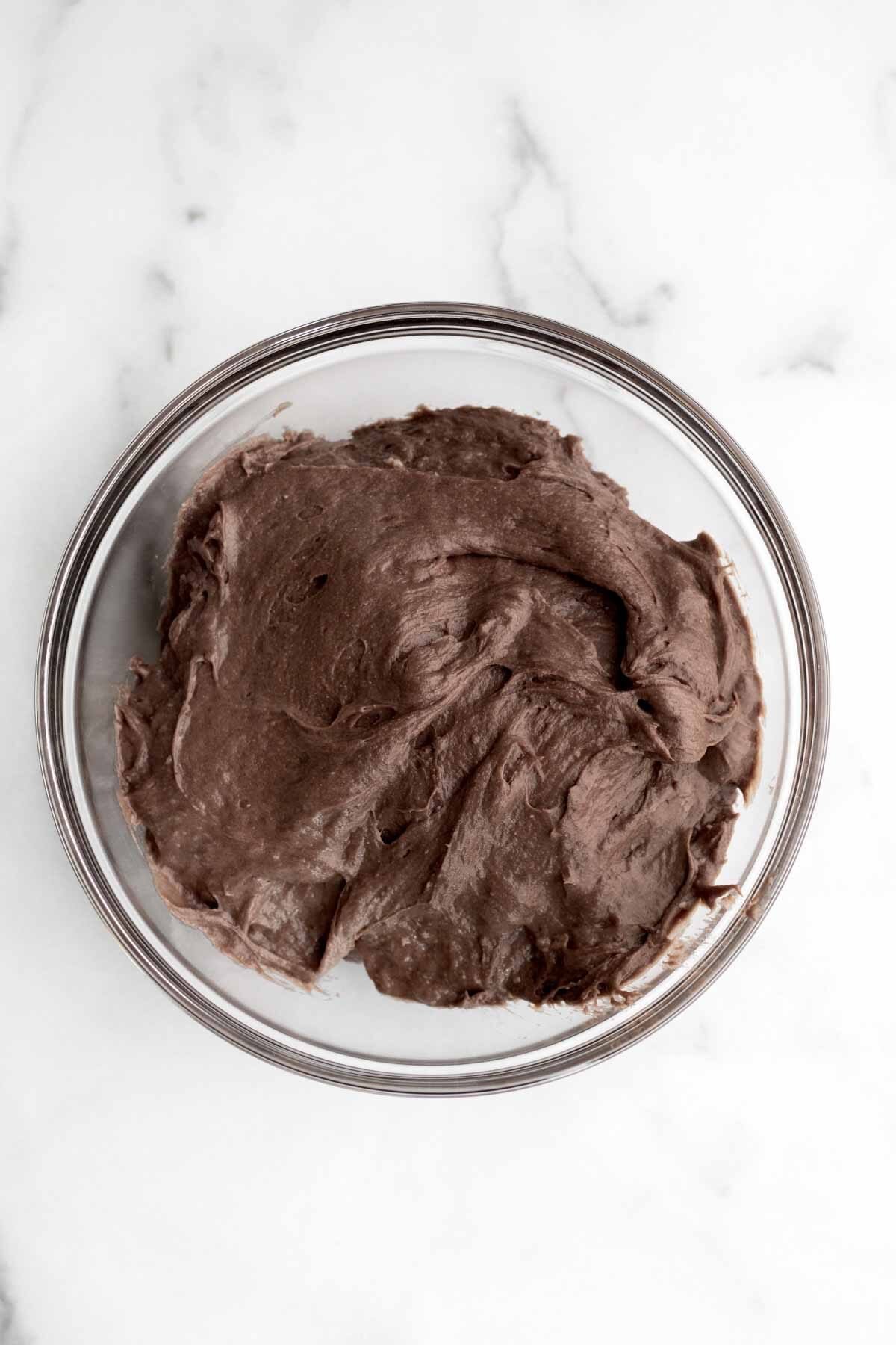 Combining the wet and dry into brown cake batter.