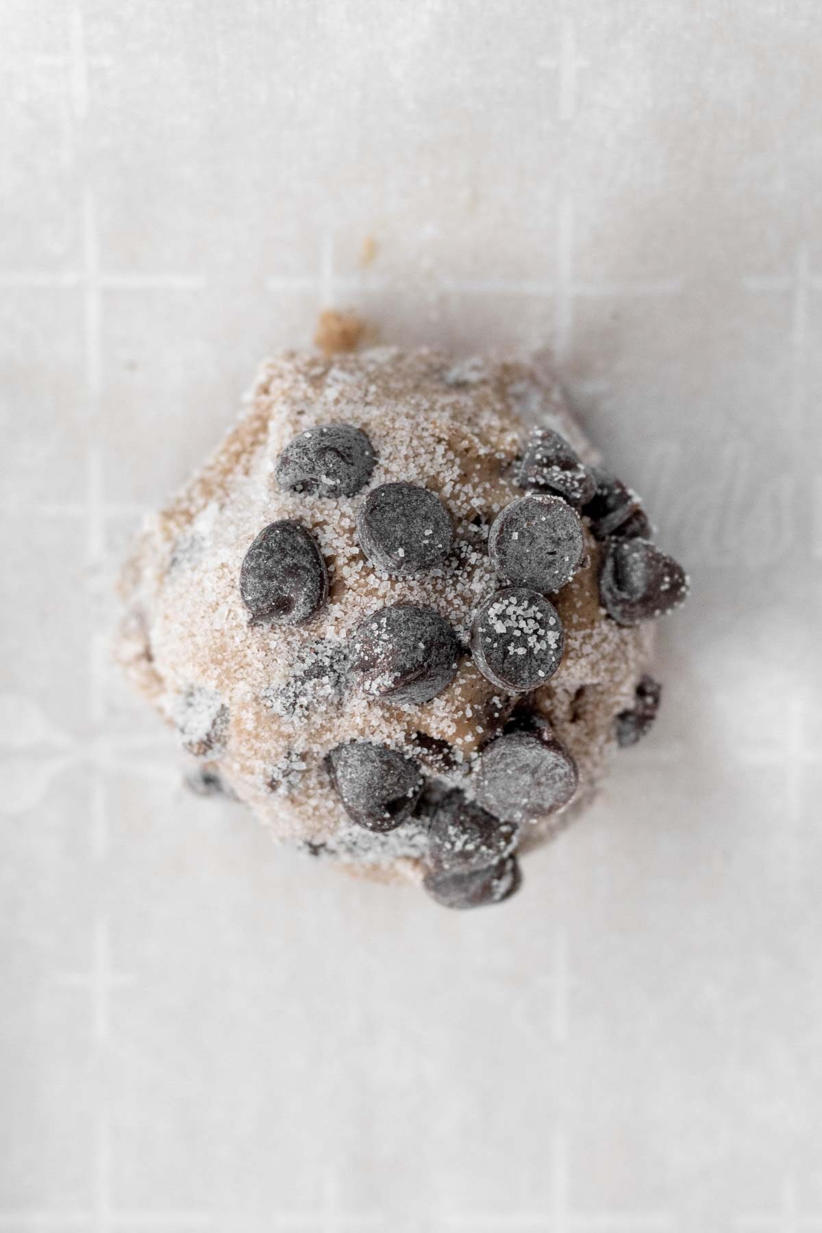 A ball of batter dusted with cinnamon sugar.