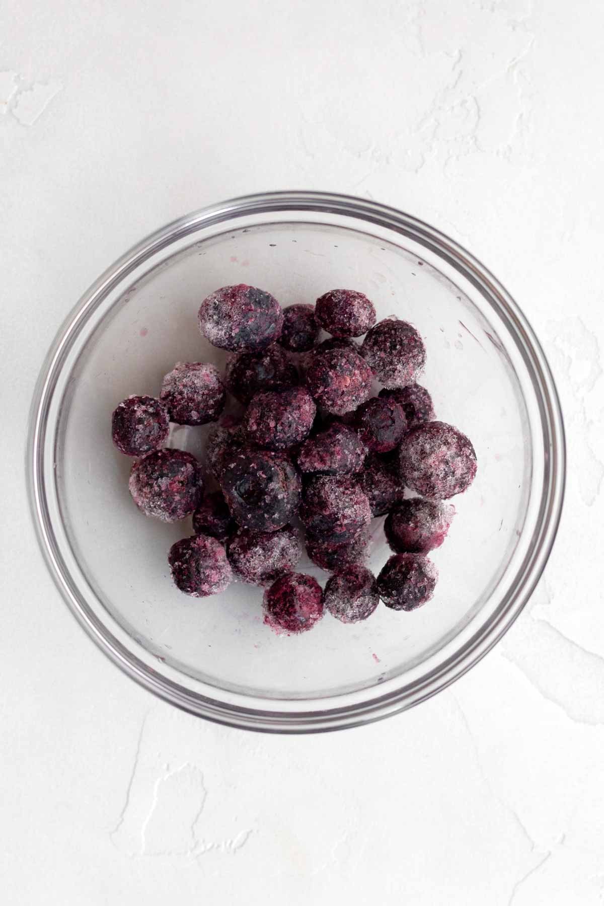 A bowl of frozen blueberries.