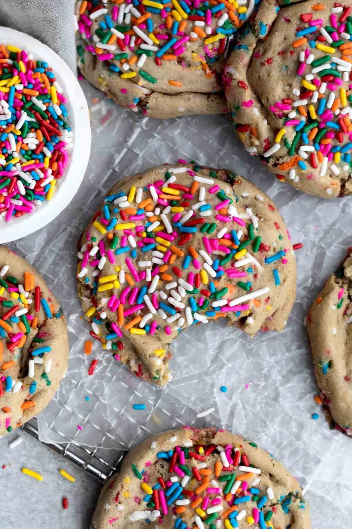 A delicious rainbow sprinkled Funfetti Cookie with a bite taken out.