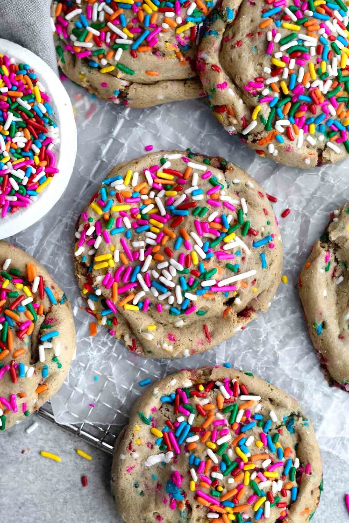 Looking down at six round cookies with sprinkles.