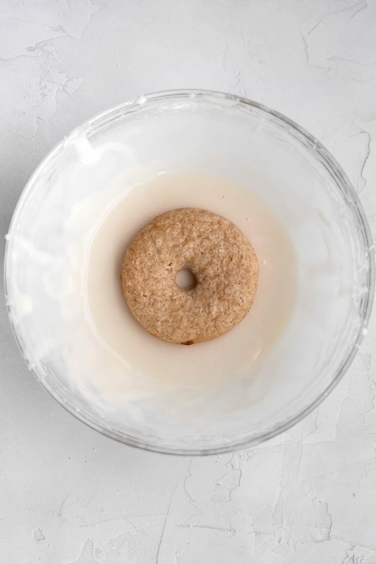 Dropping the donut in the glaze.