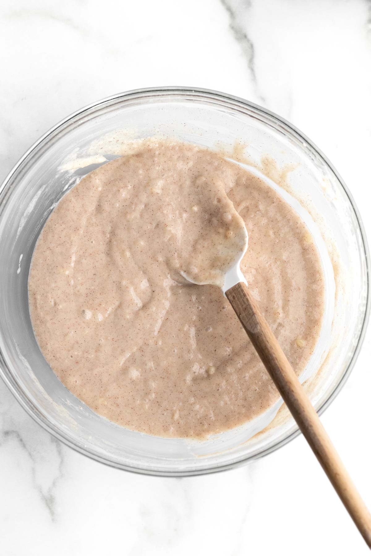 Mixing the wet and dry together in a bowl.