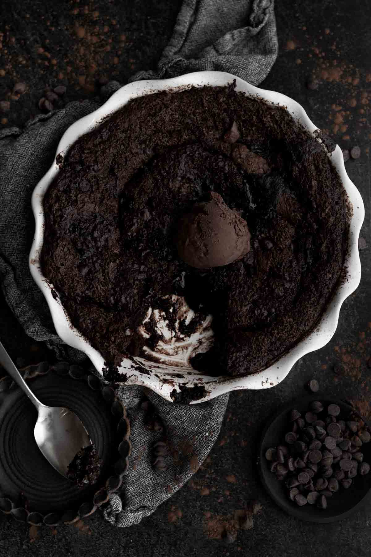 Chocolate ice cream tops a Chocolate Cobbler in a dish.