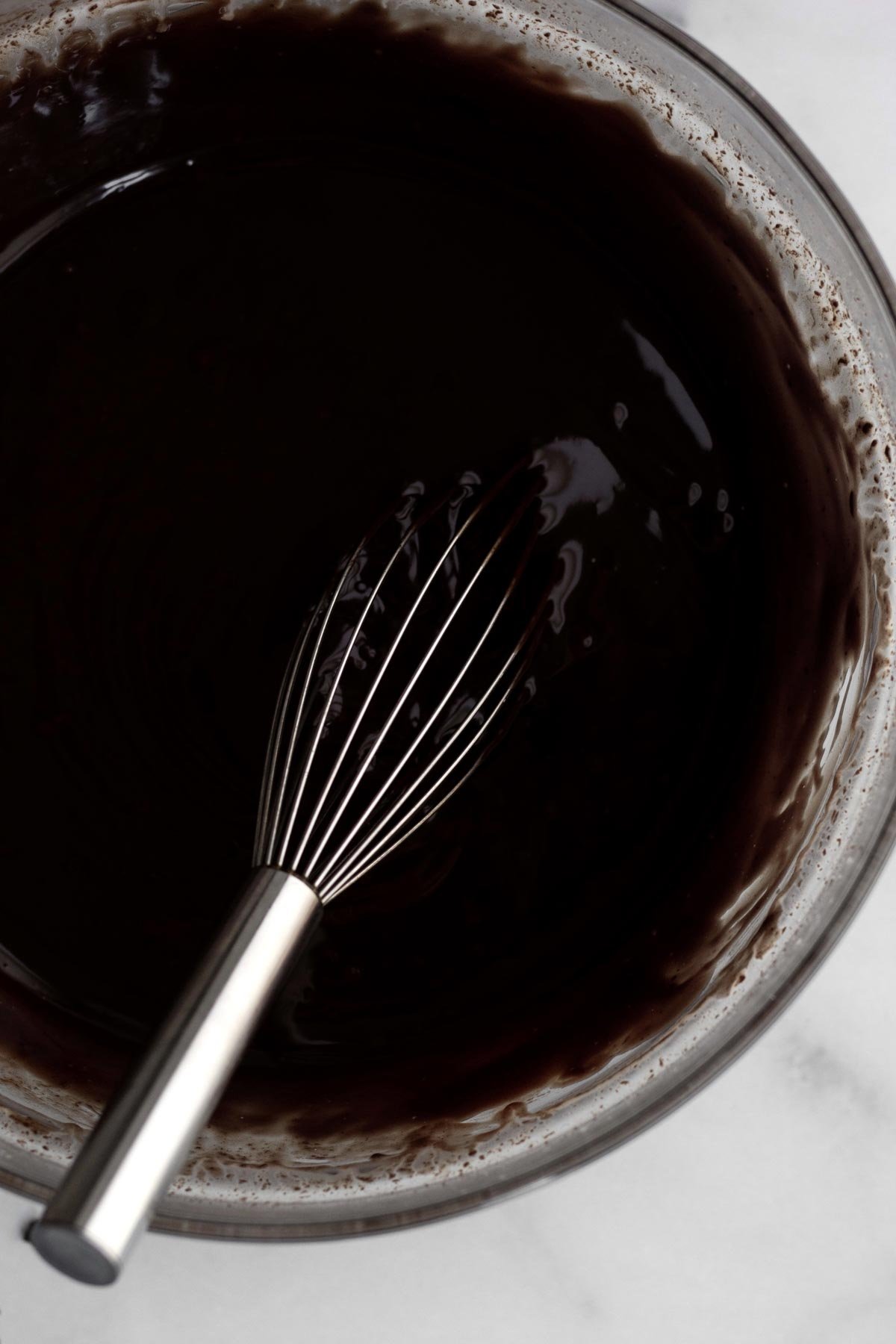 Whisking together the milk and chips to make a ganache.