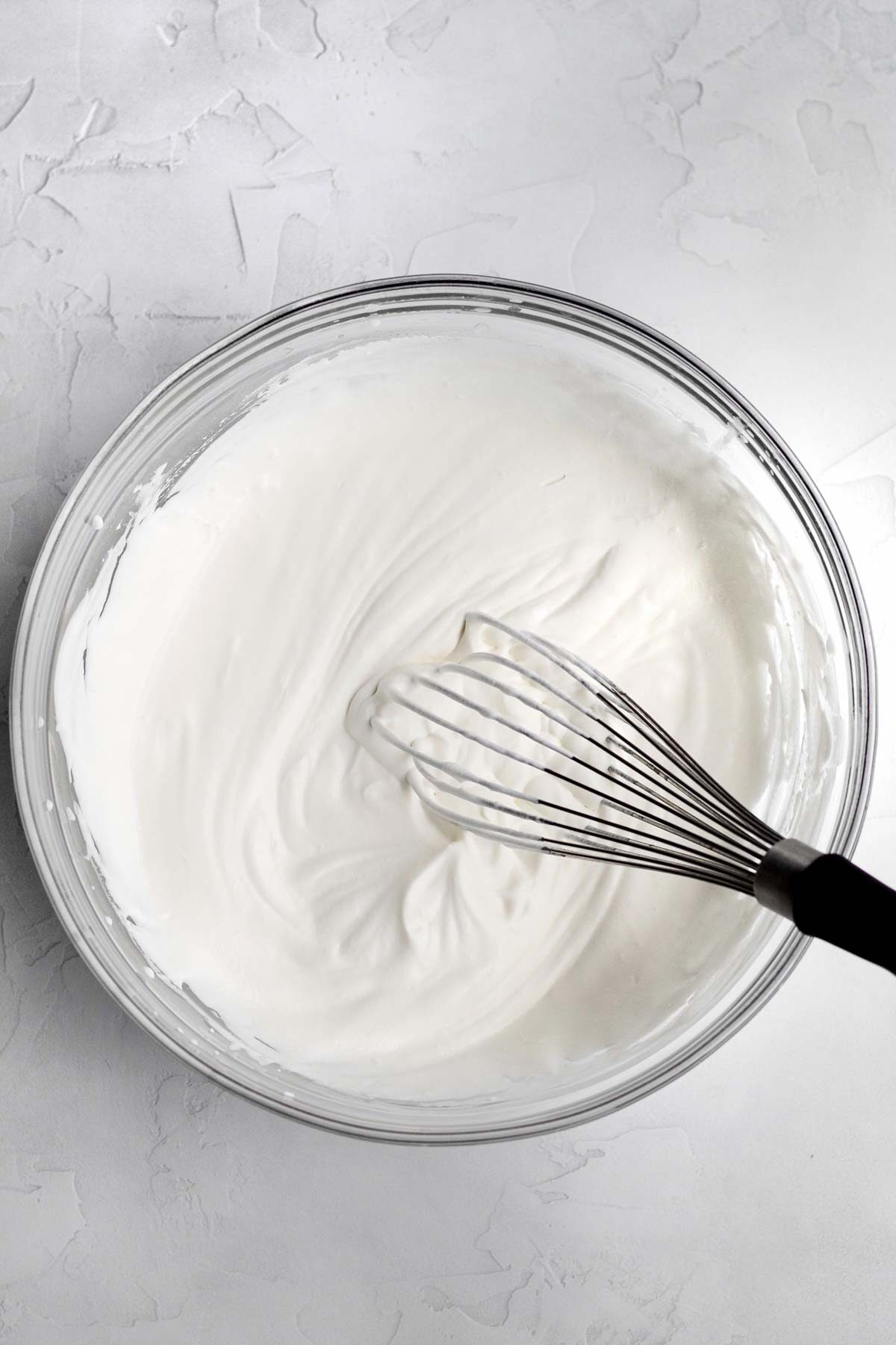 Whipped heavy cream in a bowl.