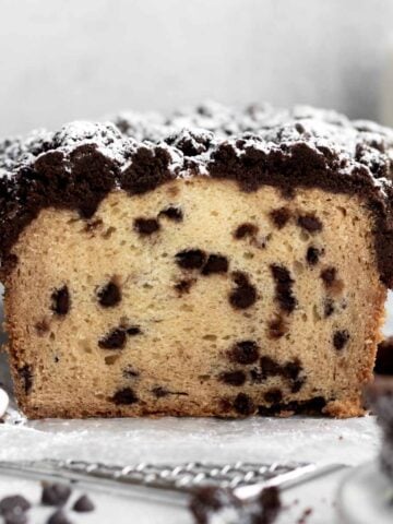 A cross section of the chocolate chip loaf with powdered sugar.