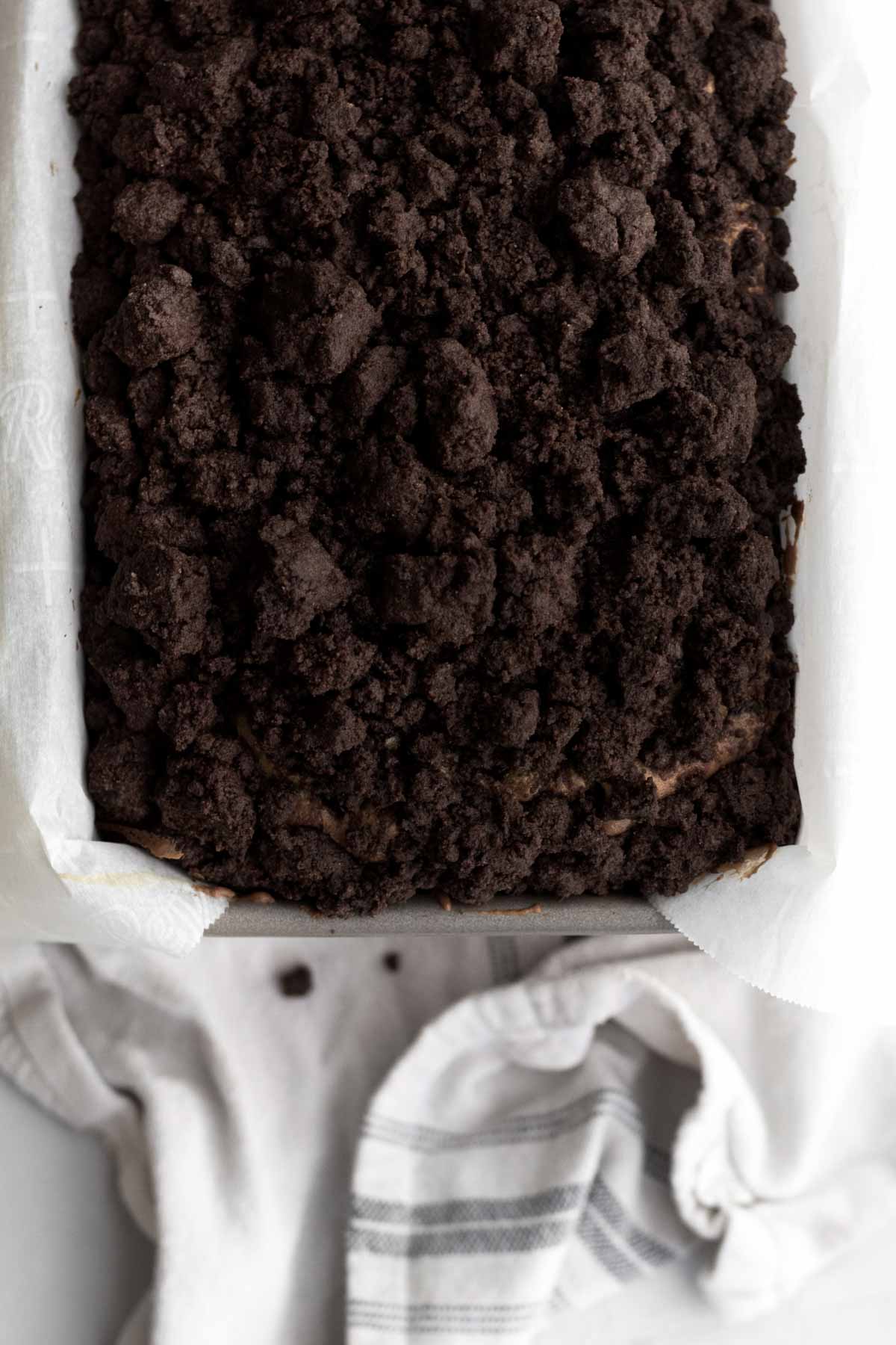 Baked loaf cake with chocolate crumbles in a pan.