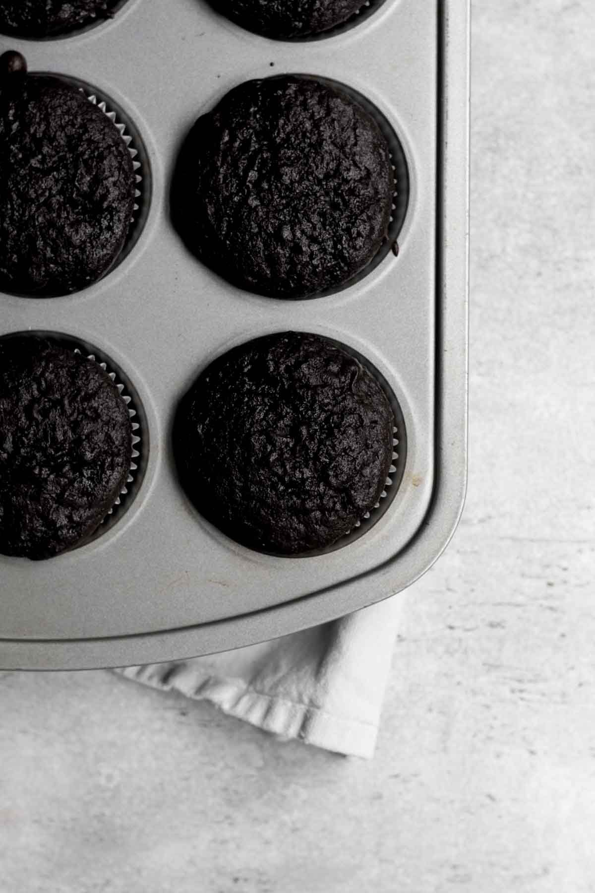 Baked cupcakes in a tin fresh from the oven.
