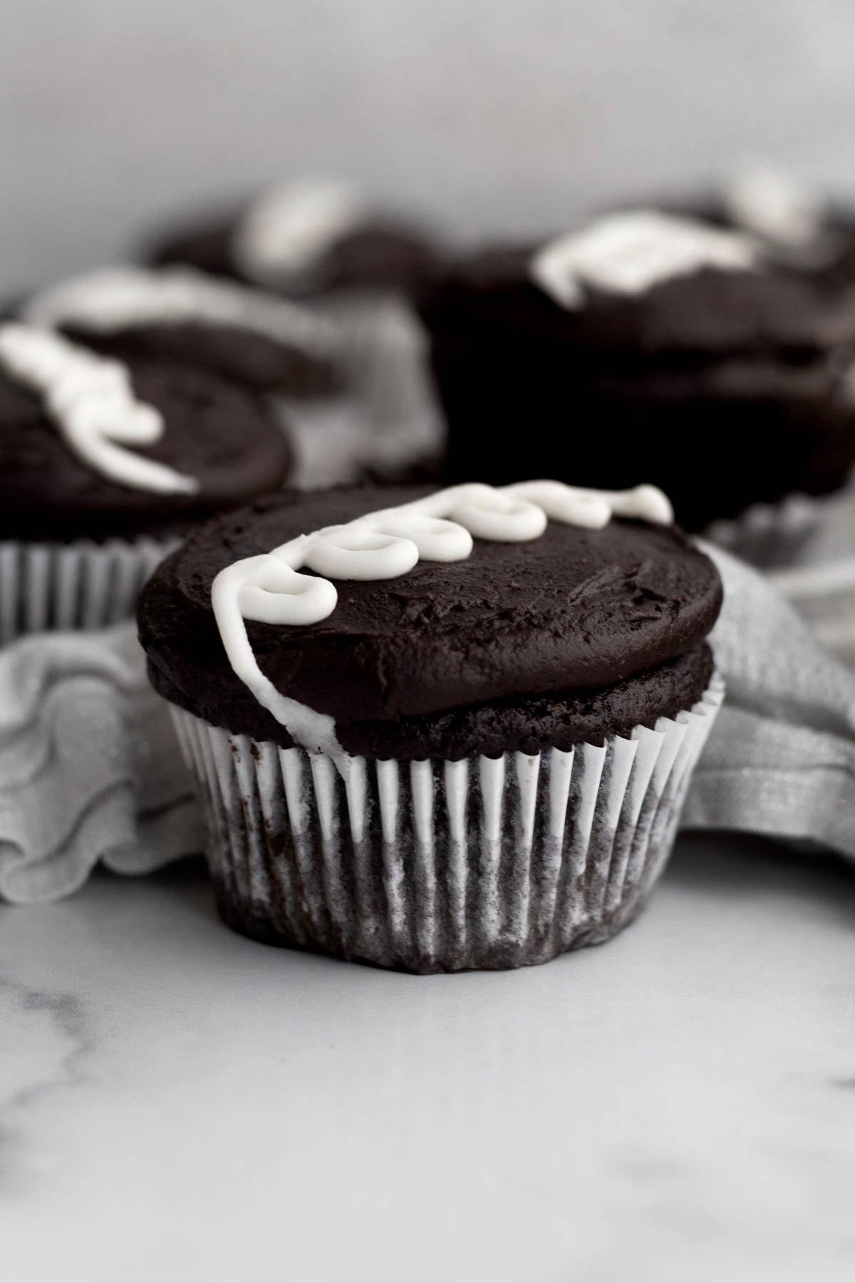A classic chocolate cupcake with a looped swirl of vanilla frosting.
