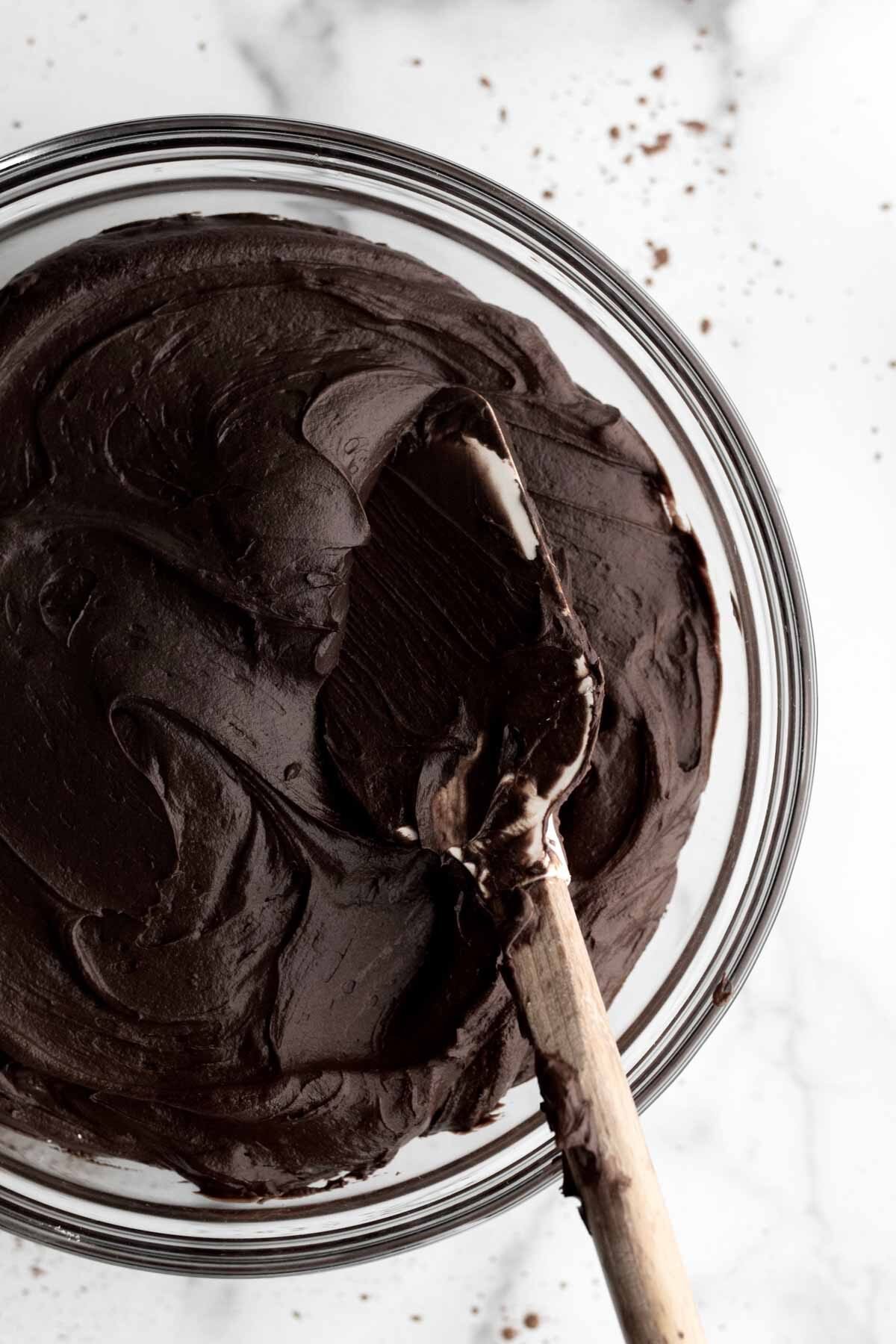 A closeup of the bowl of chocolate frosting.