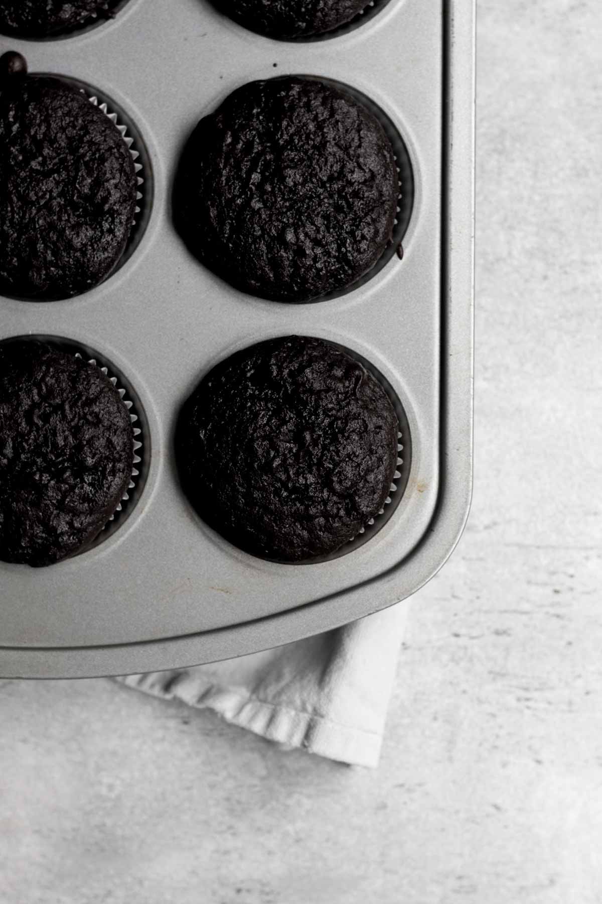 Baked chocolate cupcakes in the tin.
