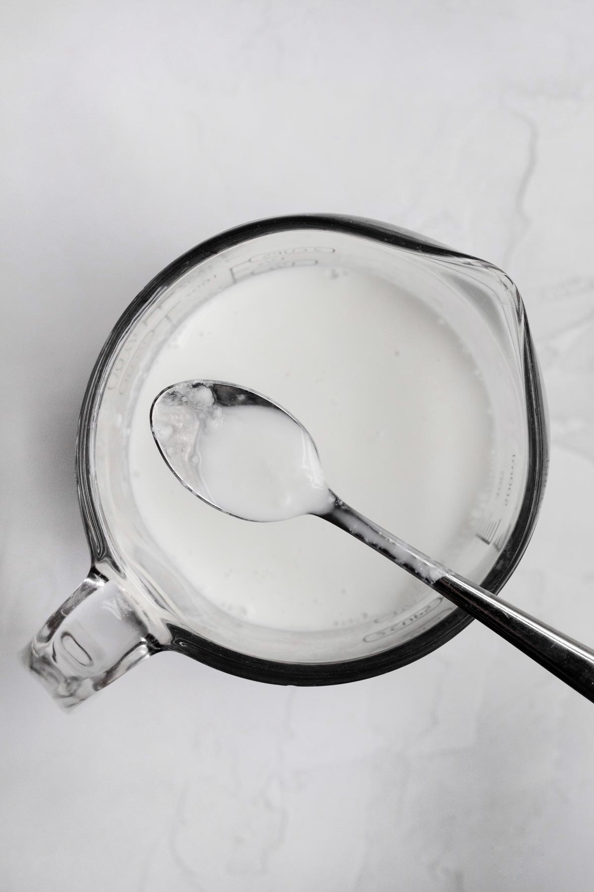 A measuring cup with homemade buttermilk.