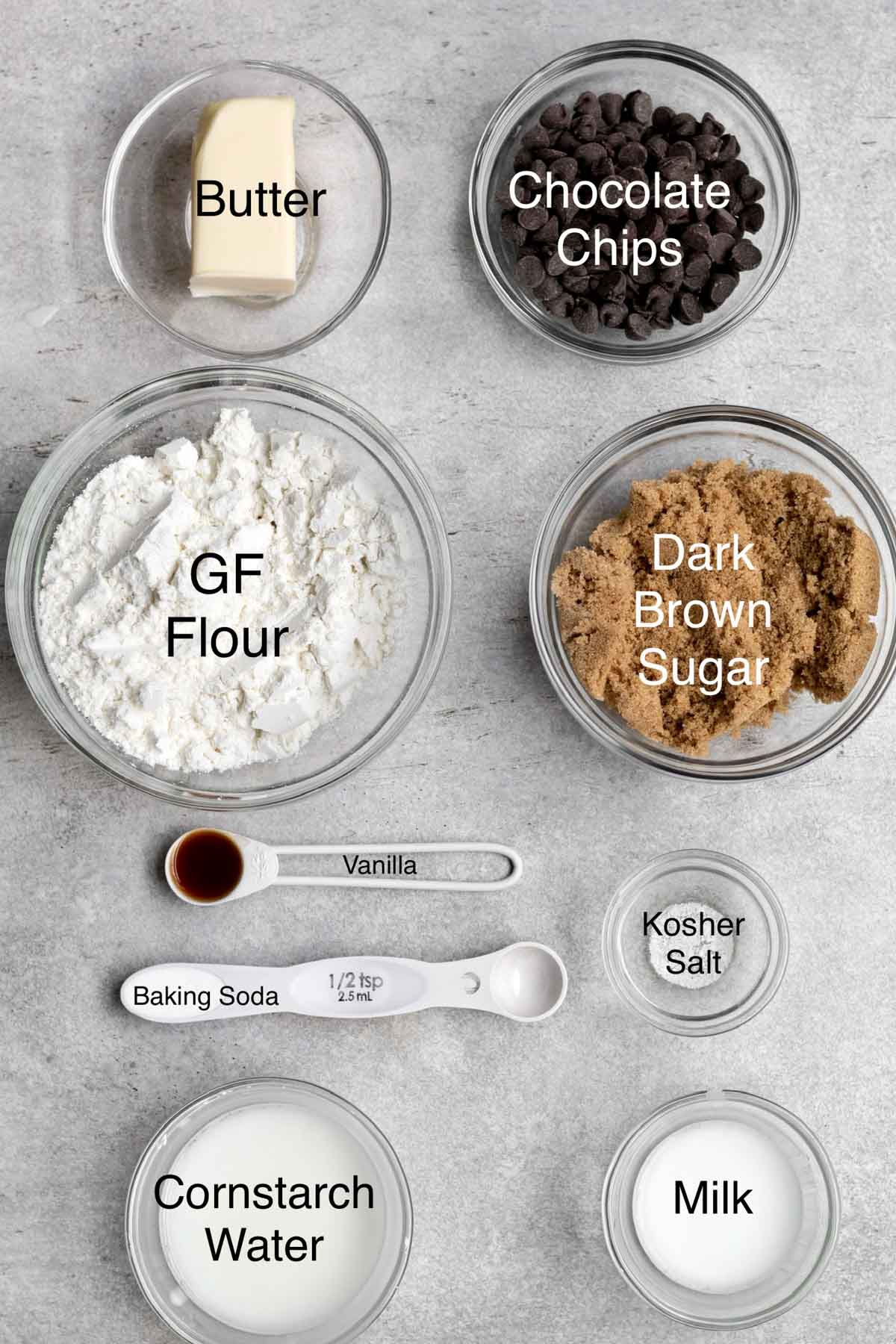 The ingredients for the cookies in separate containers with their text names over it.