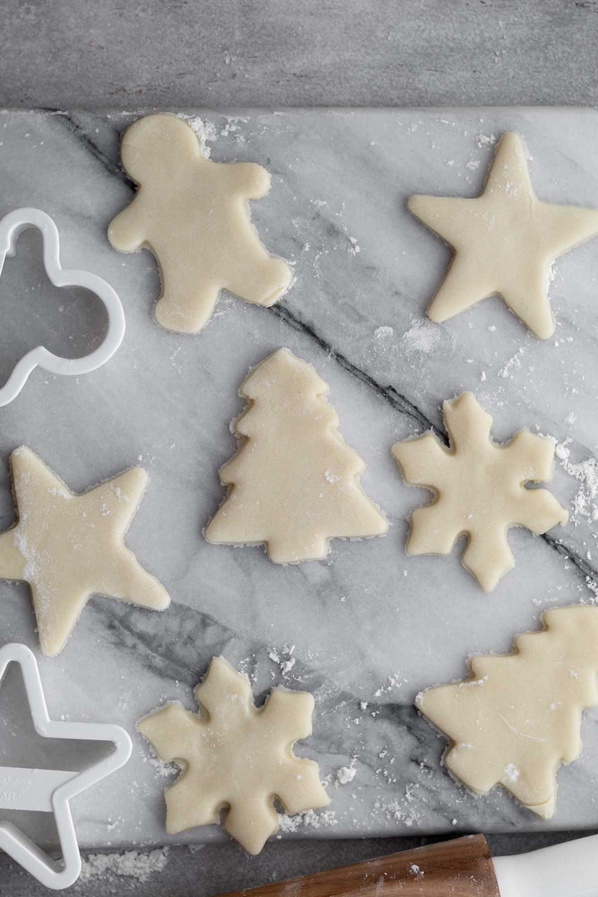 Gingerbread man, Christmas trees, stars and snowflake cookie shapes.