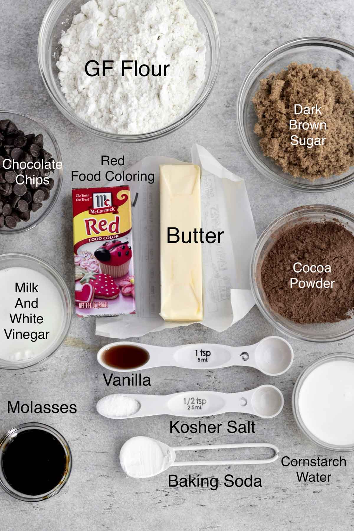 The ingredients for the cookies in separate containers with their text names over it.
