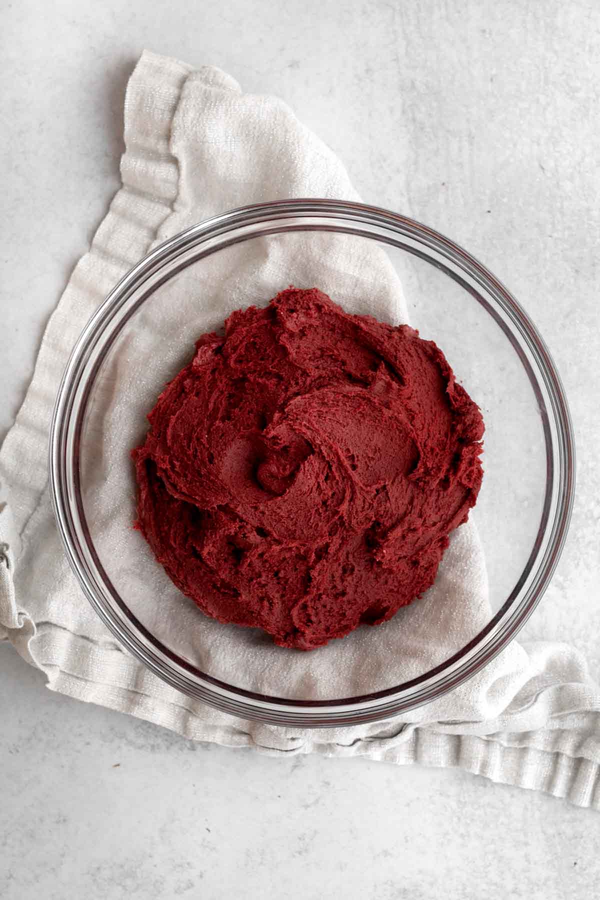 Red velvet cookie dough in a glass bowl.