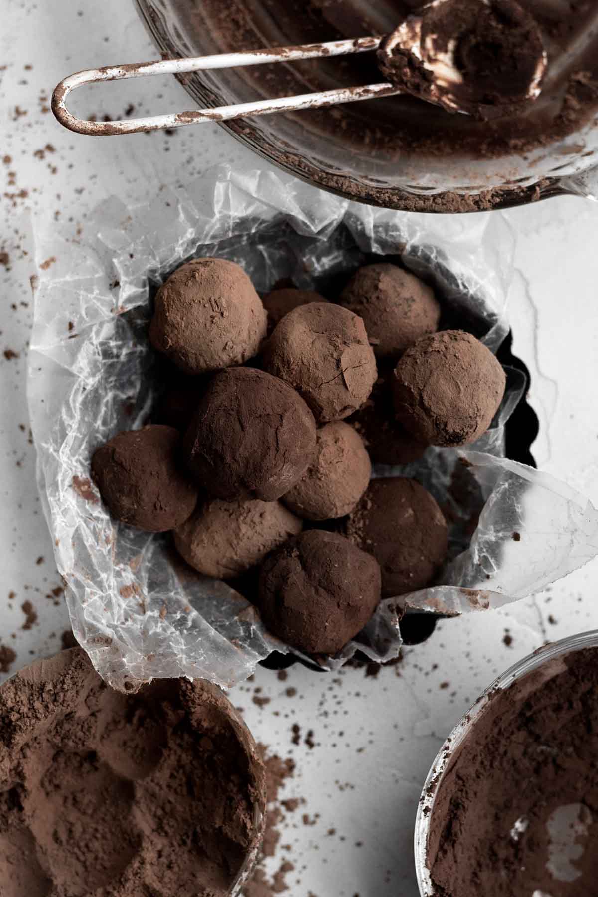Truffles freshly dusted in either regular cocoa powder or dark cocoa powder.