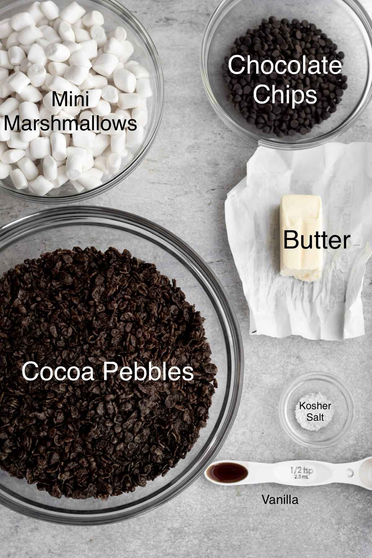 Mini Marshmallows, chocolate chips, cocoa pebbles, butter, salt and vanilla in separate containers.