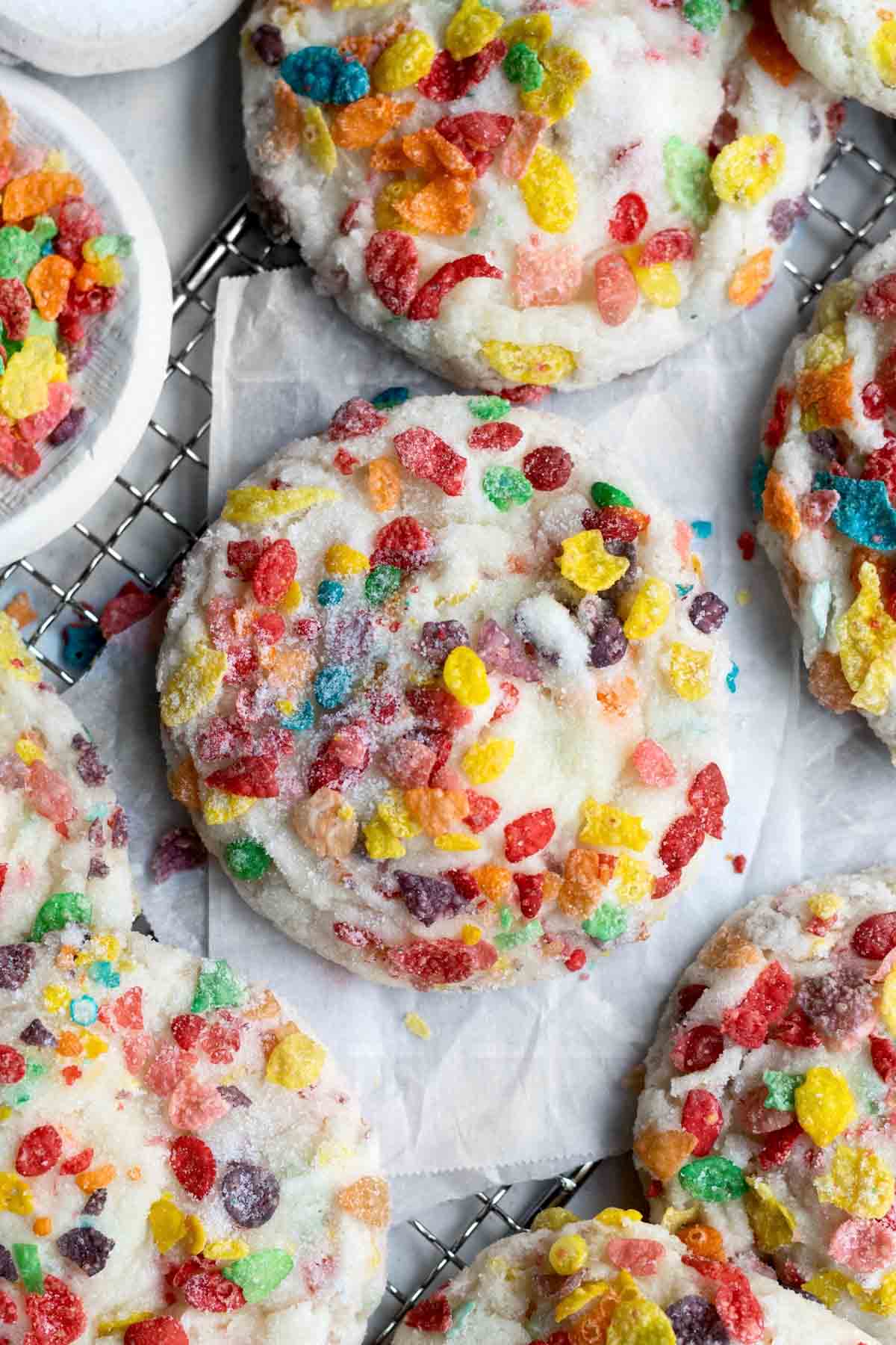Colorful round Fruity Pebbles Cookies on wax paper.
