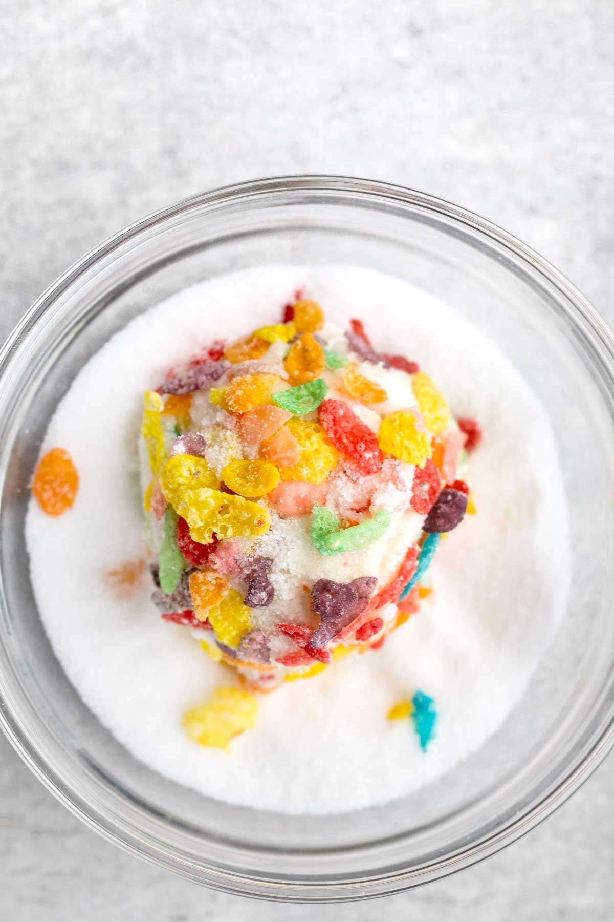 Adding extra fruity pebbles to the cookie dough and rolling the ball in sugar.