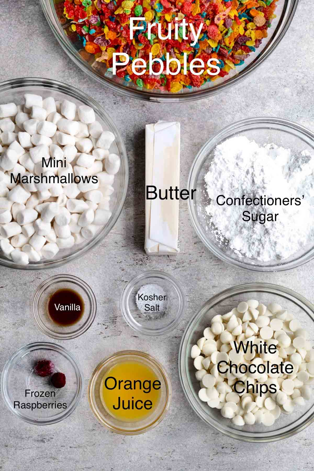 Fruity Pebbles, mini marshmallows, butter, confectioners' sugar, vanilla, kosher salt, white chocolate chips, orange juice, frozen raspberries in separate containers.