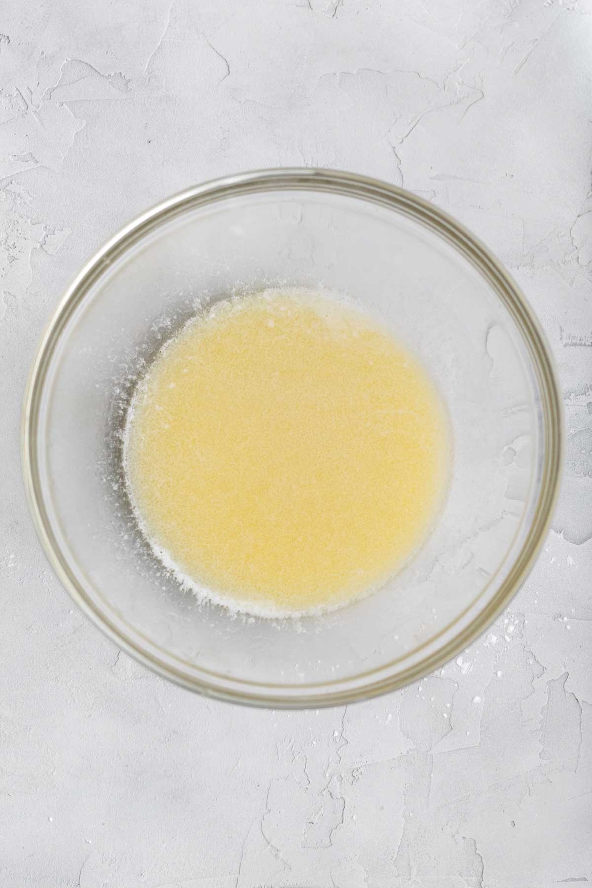 Melted butter, salt and vanilla in a glass bowl.