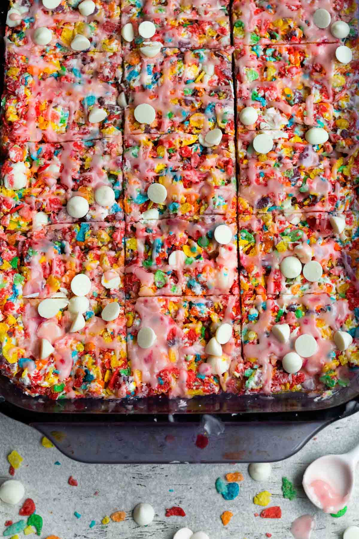 Rectangle cuts into the Fruity Pebble Treats splashed with pink fruity drizzle.