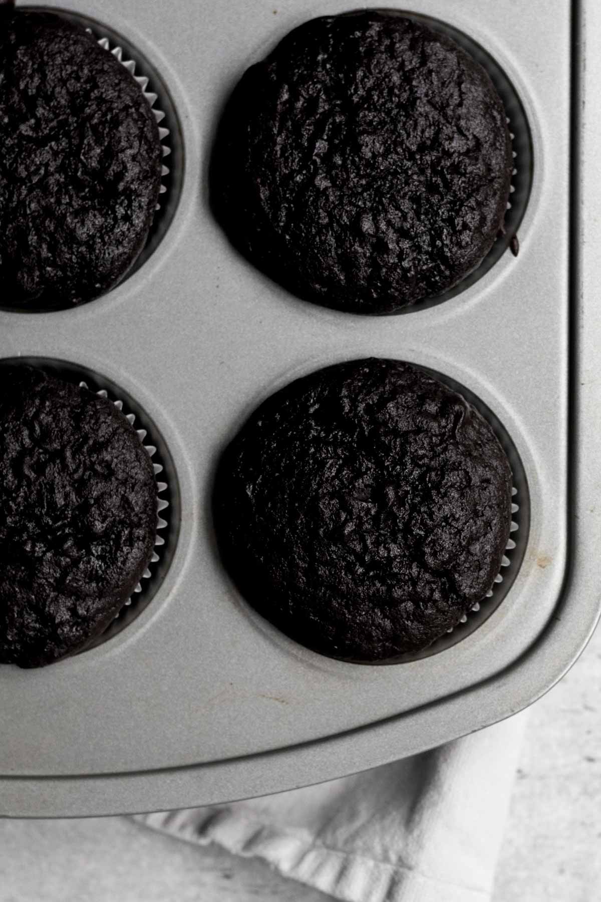 Baked risen cupcake bottoms in the tin.