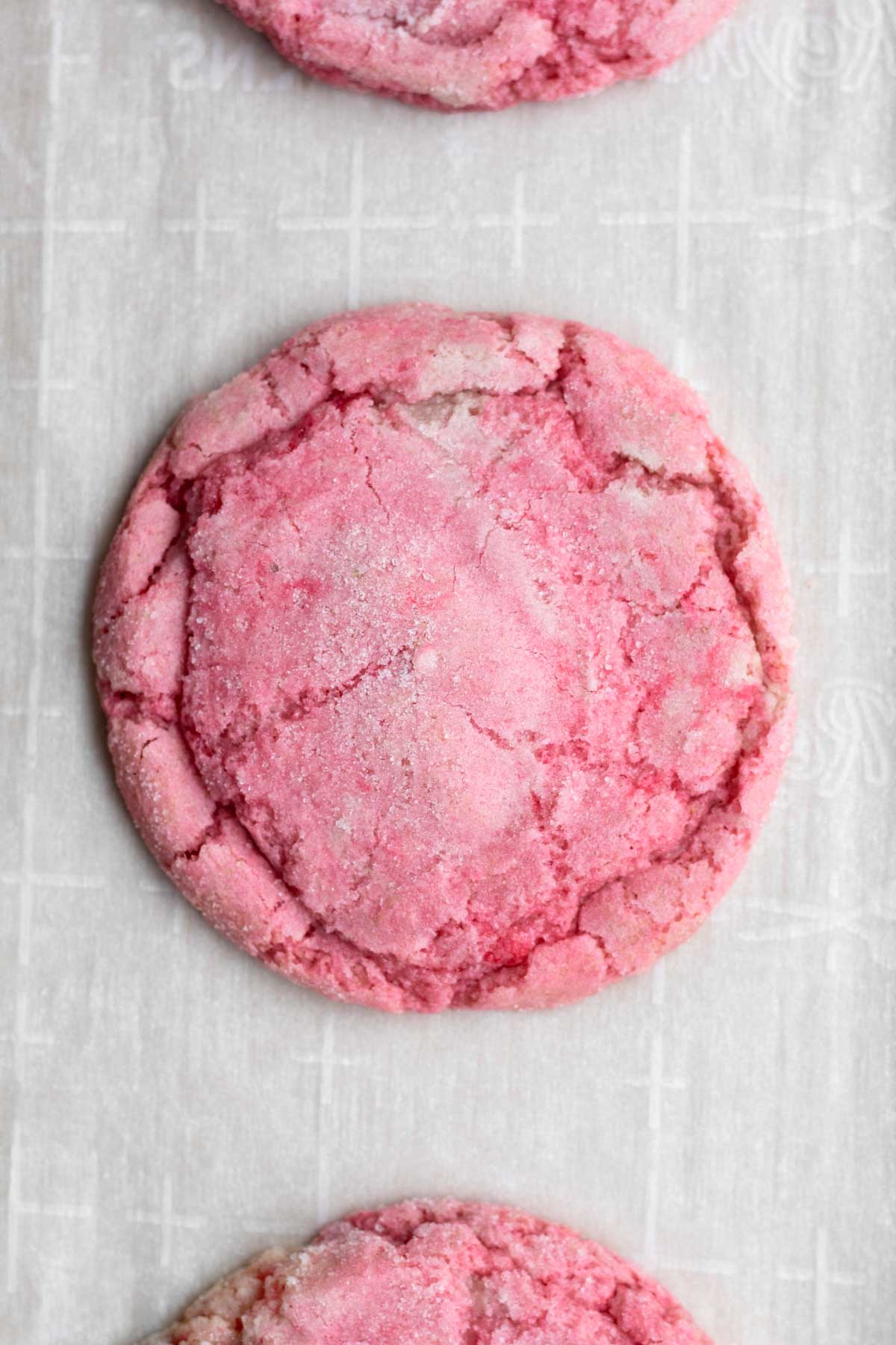 A warm Strawberry Sugar Cookie from the oven on parchment paper.