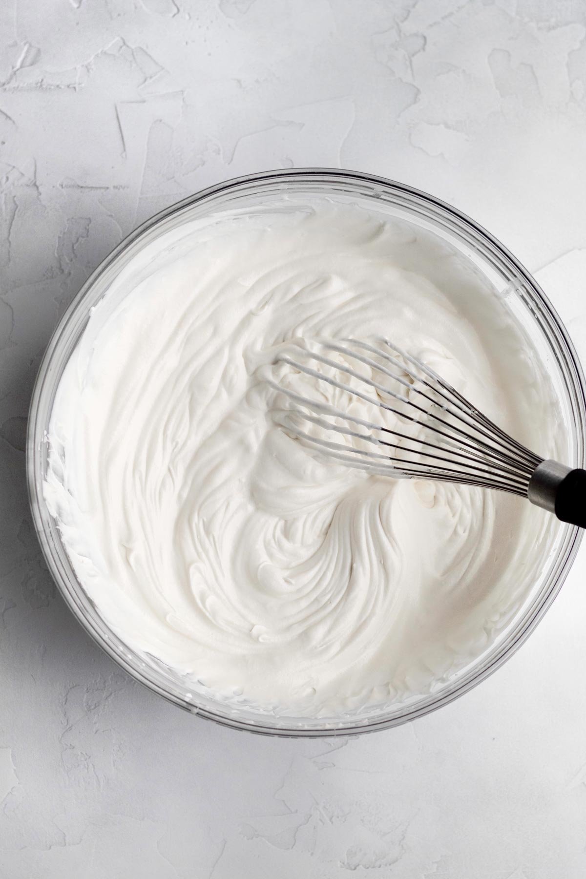 Whisking everything together into a milky white mixture.
