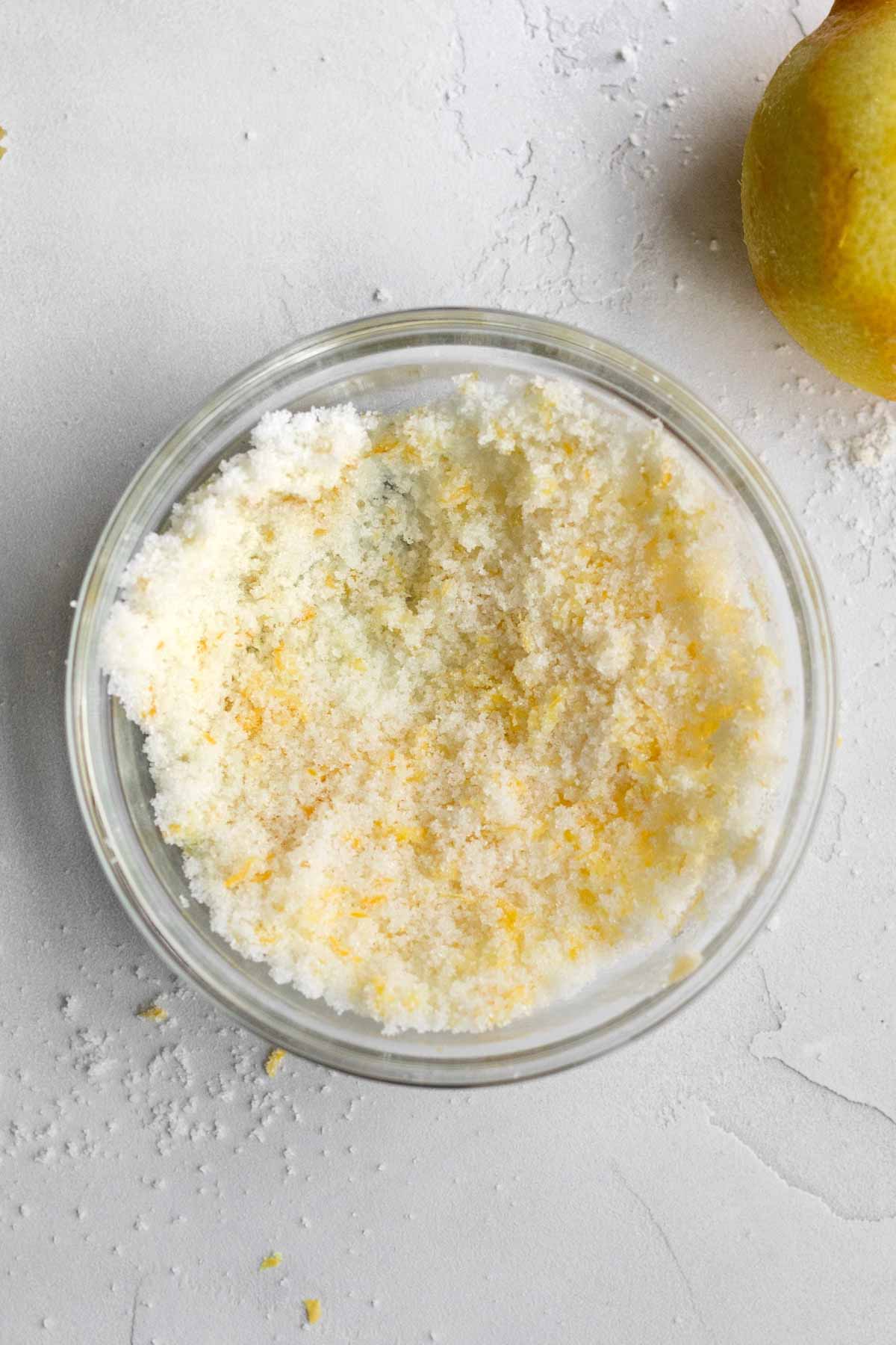 Mixing the lemon zest into the sugar.
