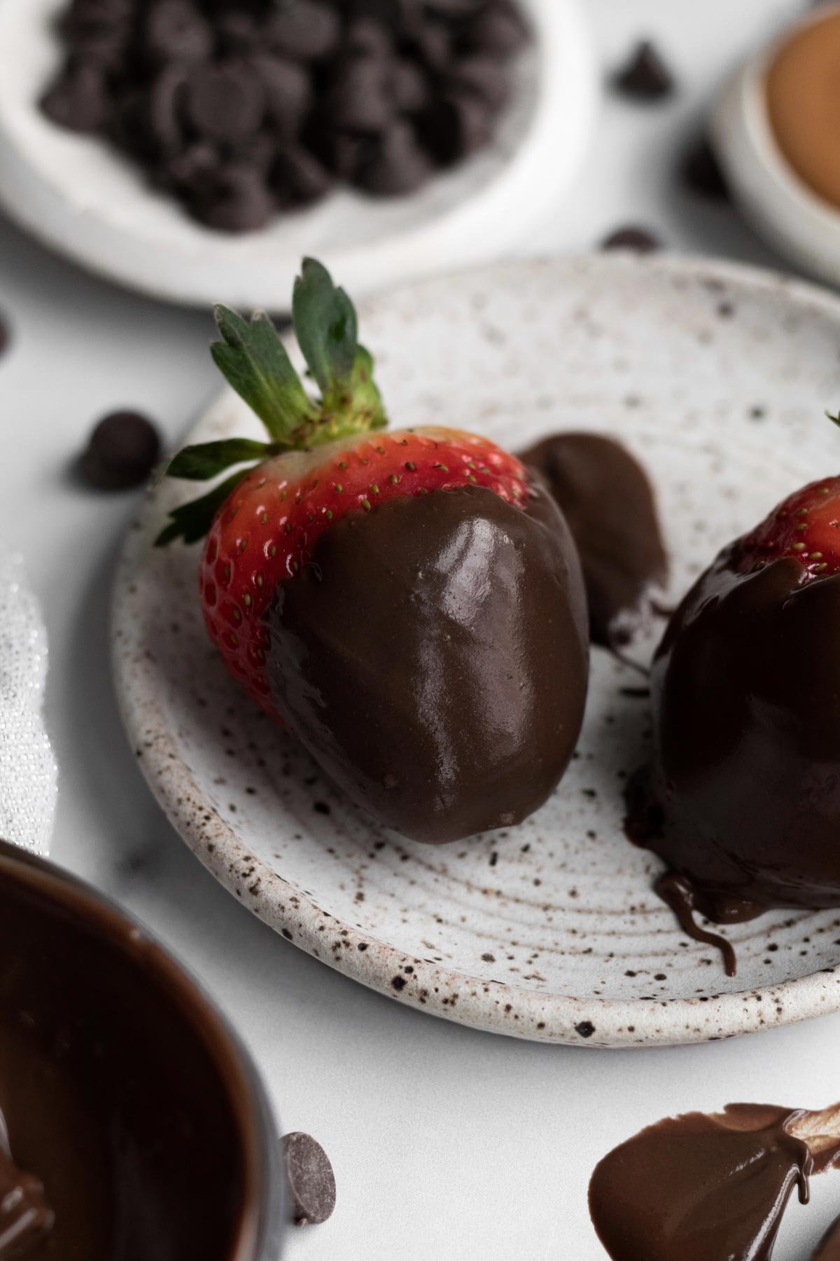 Silky and delicious Nut Free Chocolate Spread covers this fresh red strawberry.