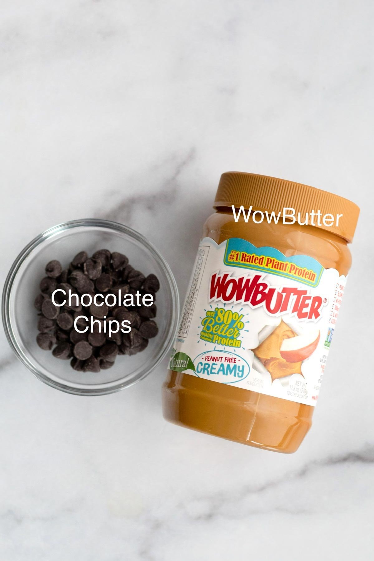 Chocolate chips in a glass bowl and a container of Wow Butter.