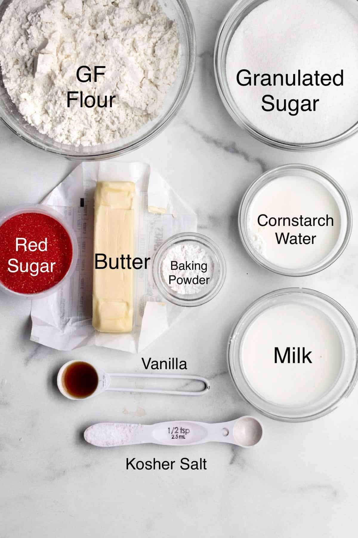 Gluten free flour, granulated sugar, red sugar, butter, baking powder, cornstarch water, vanilla, salt and milk in separate containers.