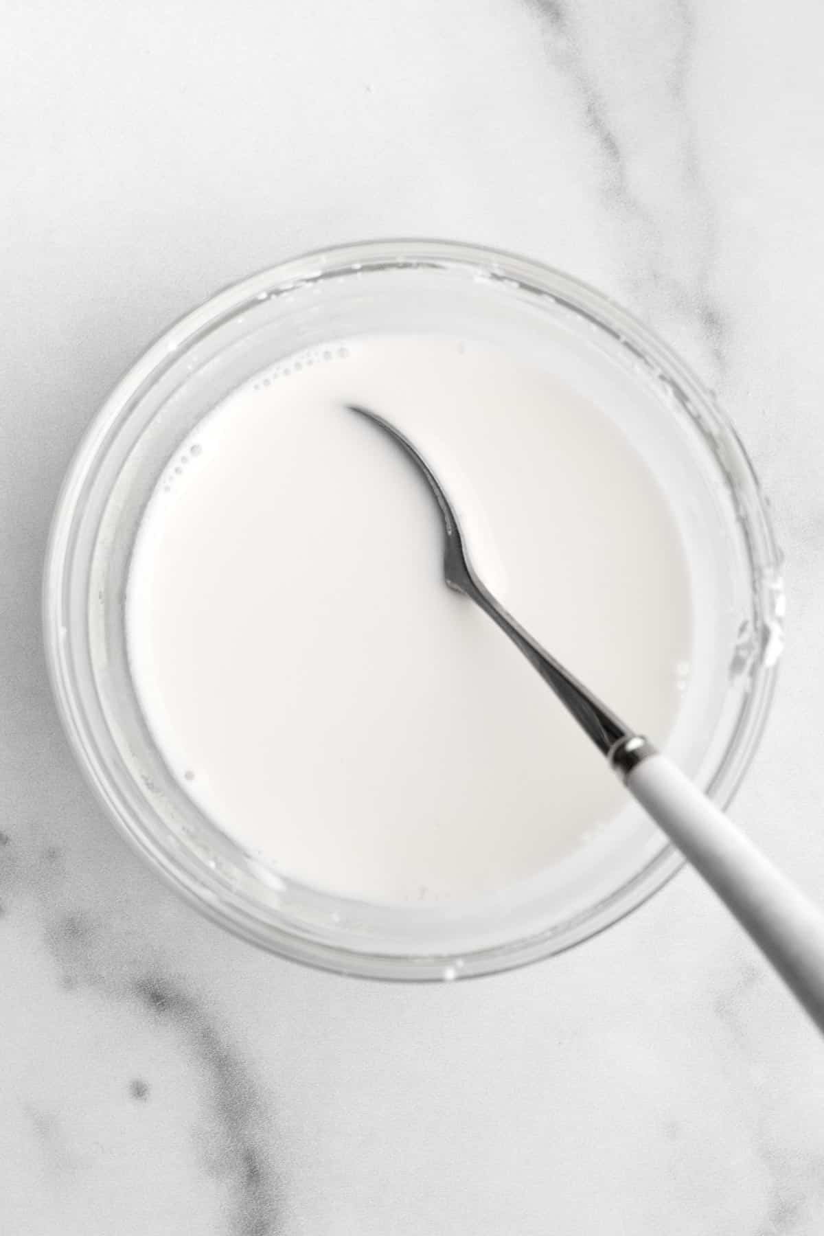 A spoon with the milky cornstarch water.