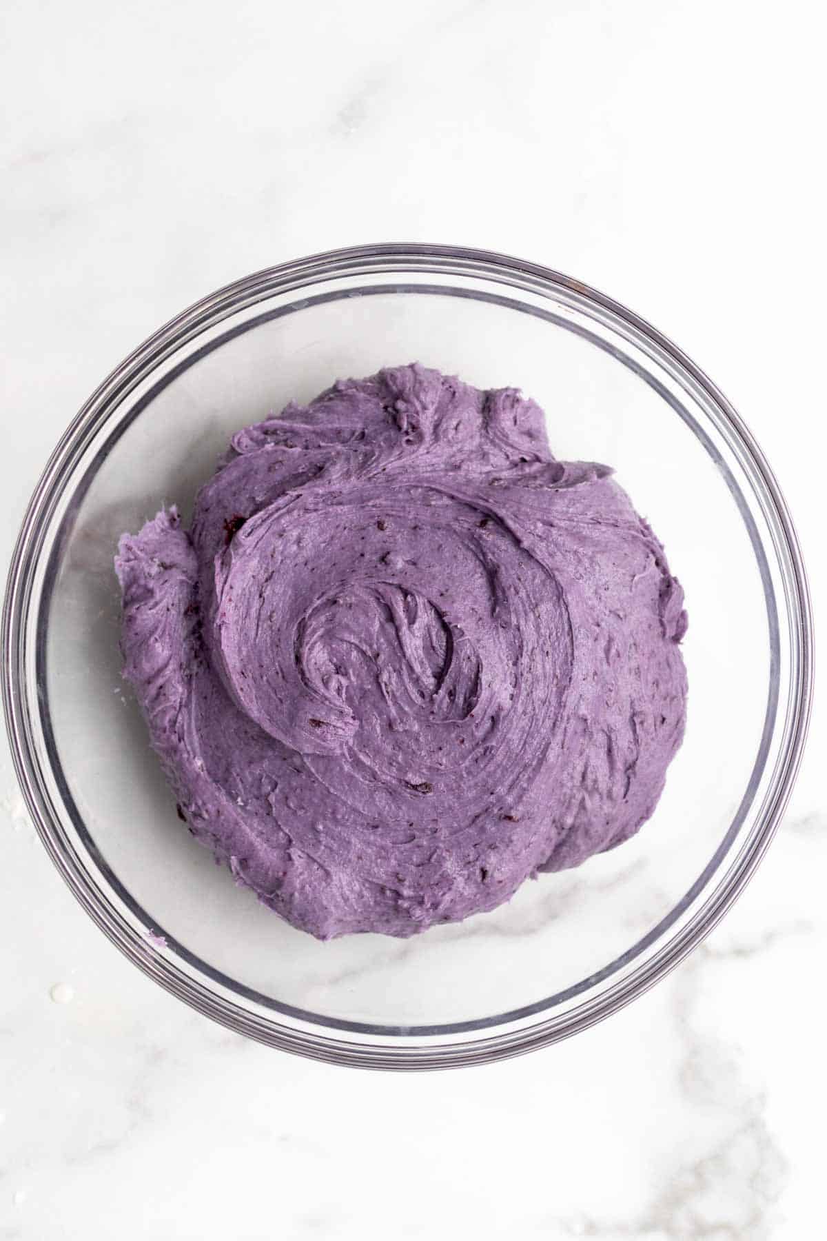 Mixing the wet and dry ingredients into a purple cookie dough.