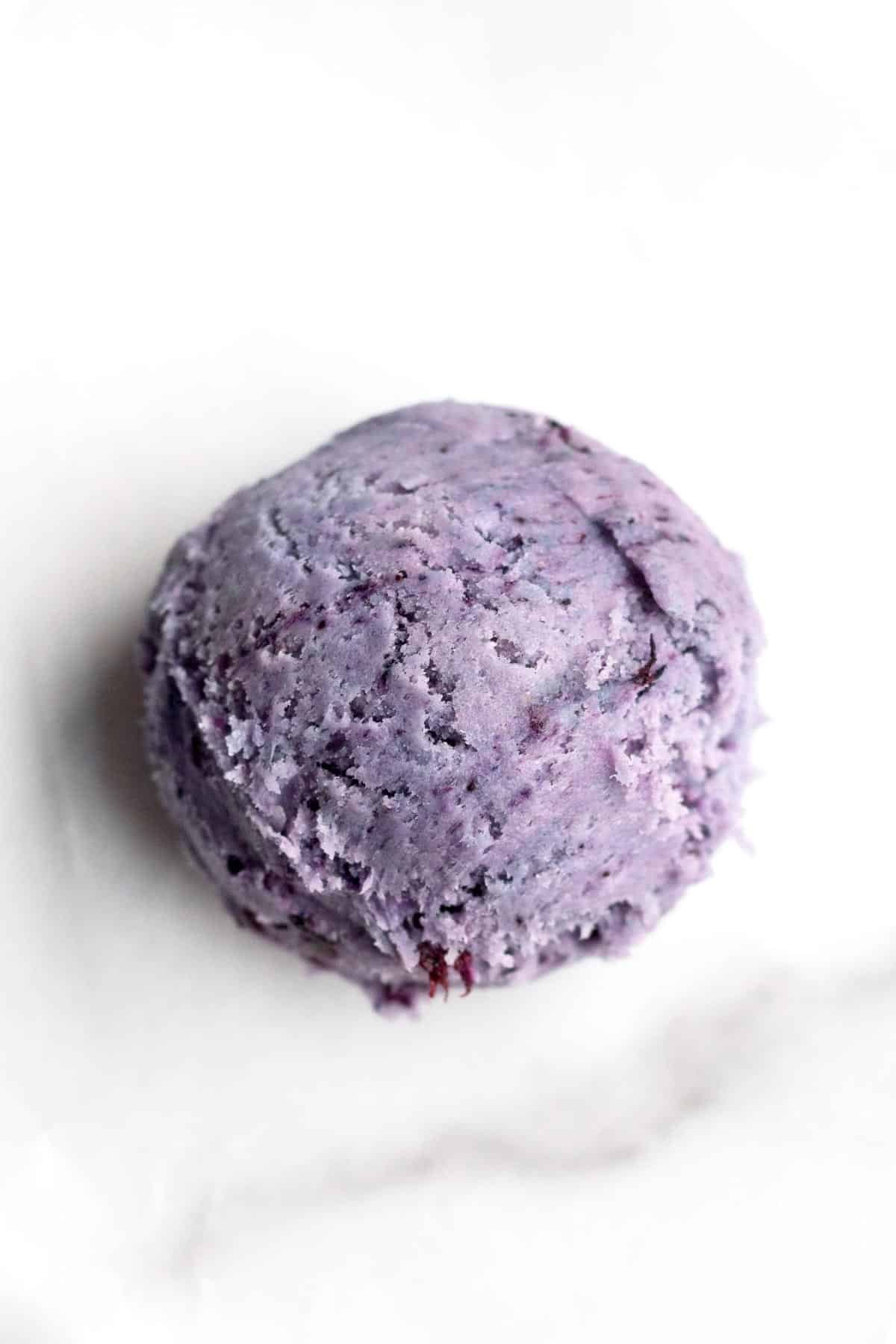A purple scooped ball of cookie dough.