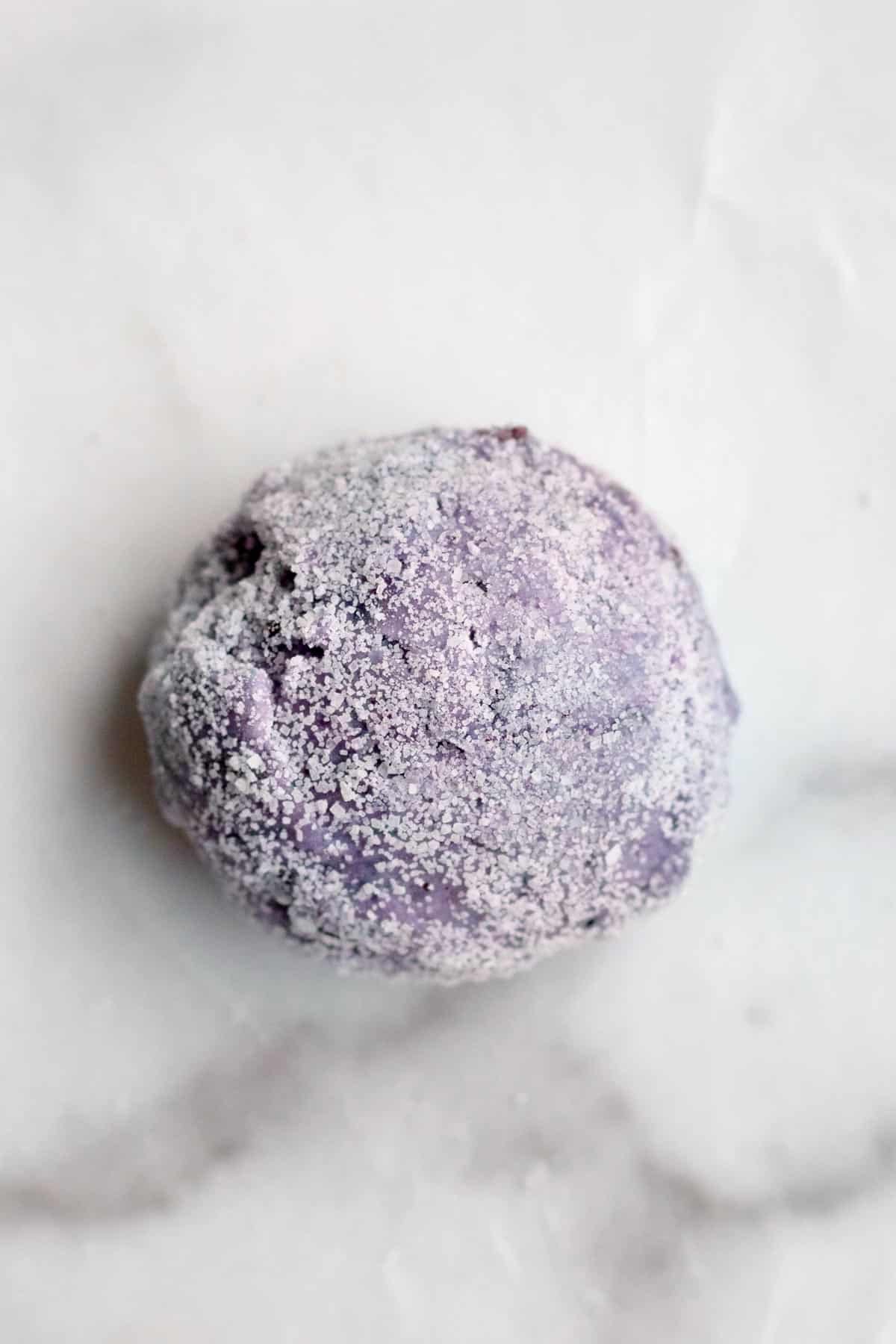 A cookie dough ball rolled in granulated sugar.