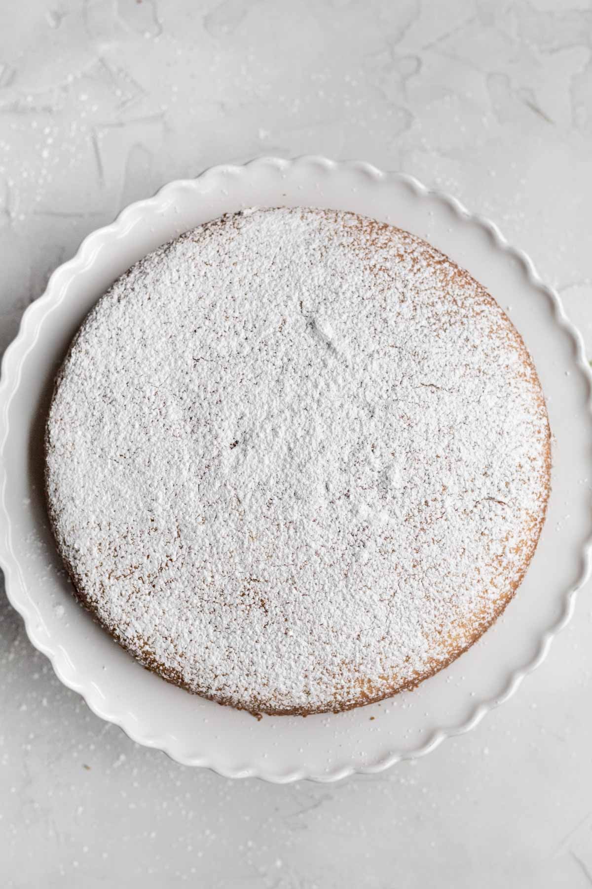 A light coat of confectioners' sugar is added to the top of the cake.